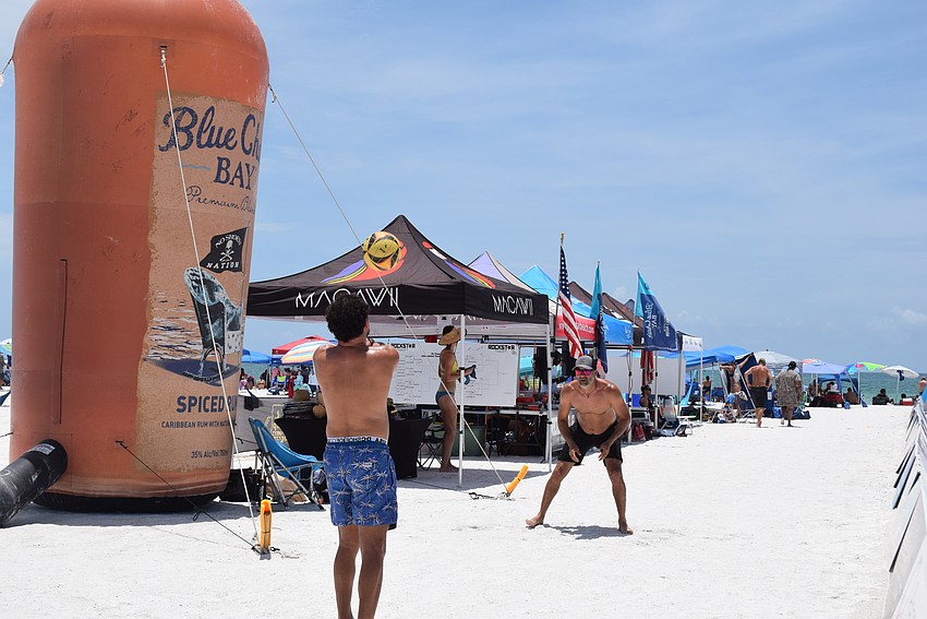 Players at the July Independence Volleyball Tournament on Lido Key practicing between games.