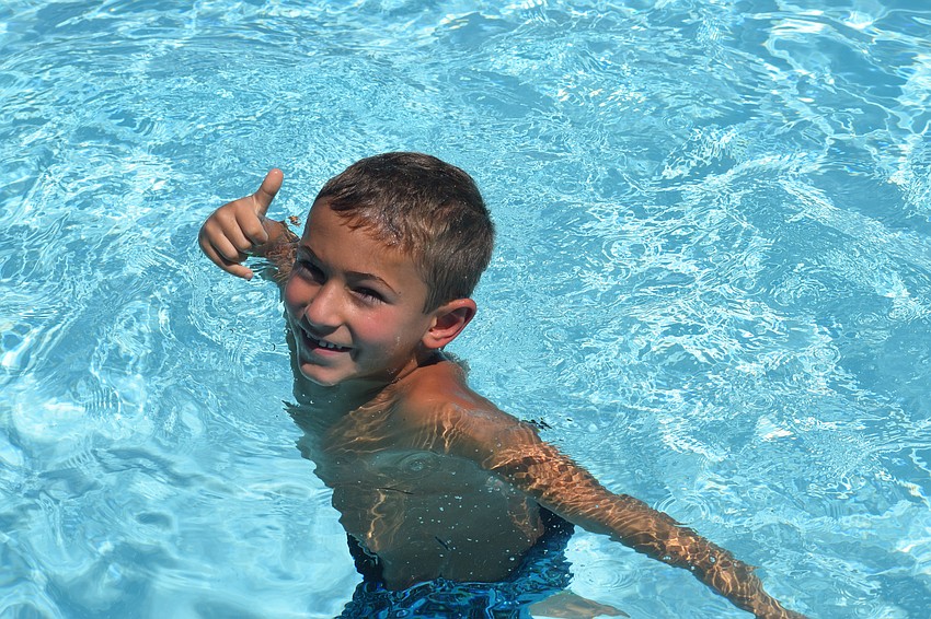 Xavier Centrella, who is 6, takes a break from the heat by taking a dip in the YMCA pool.