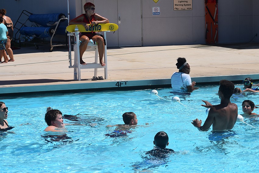 YMCA campers and counselors play Marco Polo.