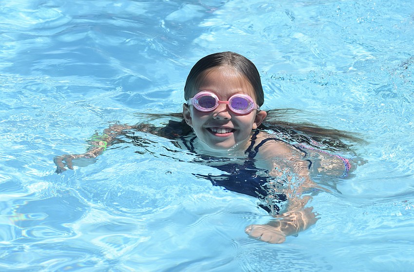 Kaytlyn Fleming, who is 7, makes the most of her time in the YMCA pool. Fleming says swimming is her favorite activity at camp.