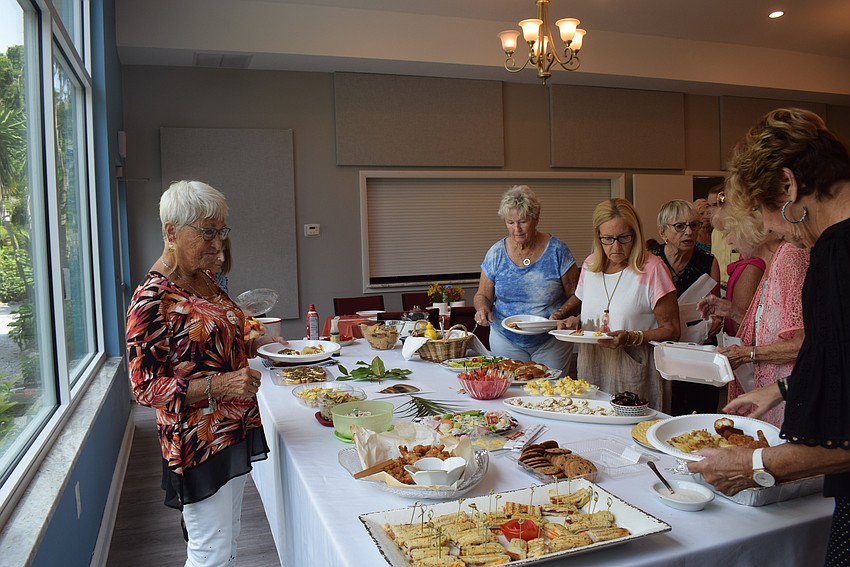 Longboat Island Chapel enjoys a food spread at their 