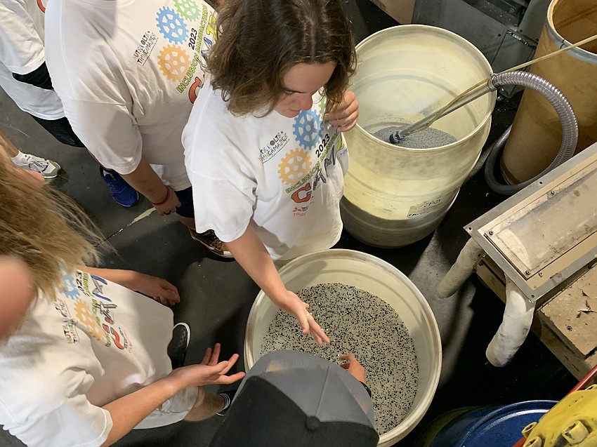 Sophia Gaum, at Aladdin Equipment Company, feels the material before it gets manufactured into pool and spa replacement parts.