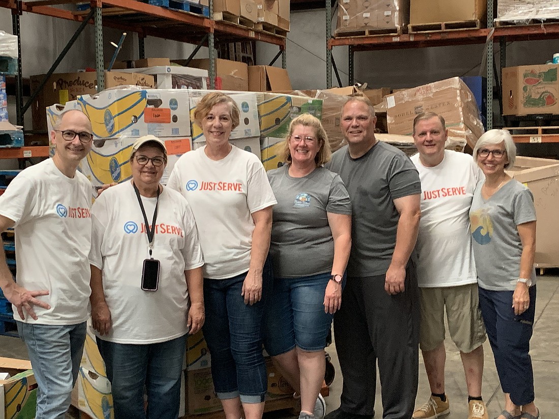 Members of The Church of Jesus Christ of Latter-day Saints, West Stake campus, helped unload a trailed filled with non-perishable foods at the Southeastern Food Bank.