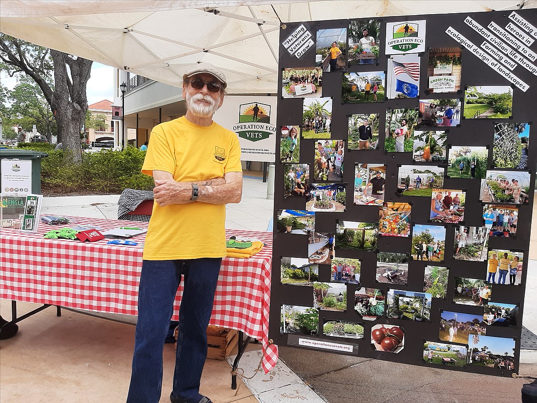 Navy veteran John Hynal shares Operation Eco Vets' mission at a farmers market.