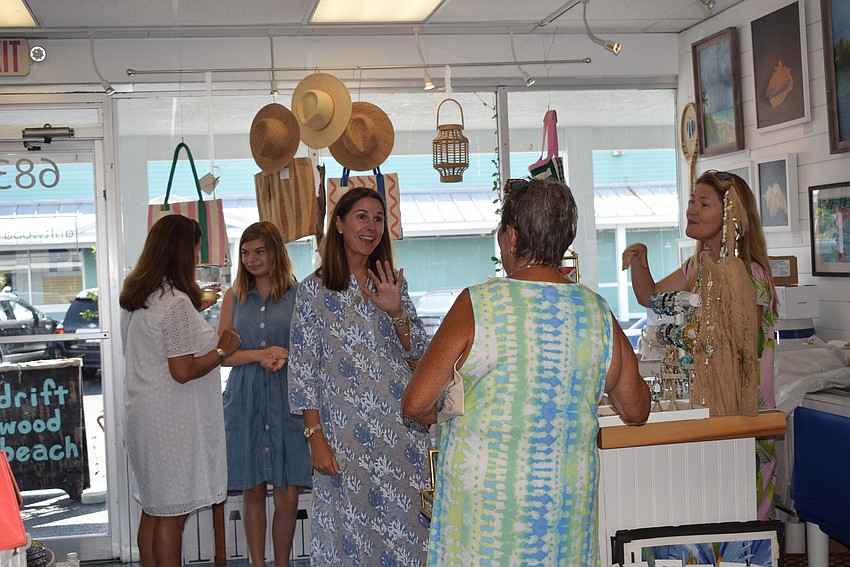 People mingling at Summer Night Out at Whitney Beach Plaza