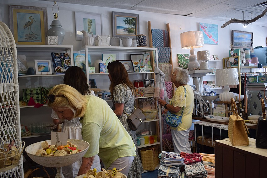 People browsing Driftwood Beach Home and Garden during Summer Night Out.