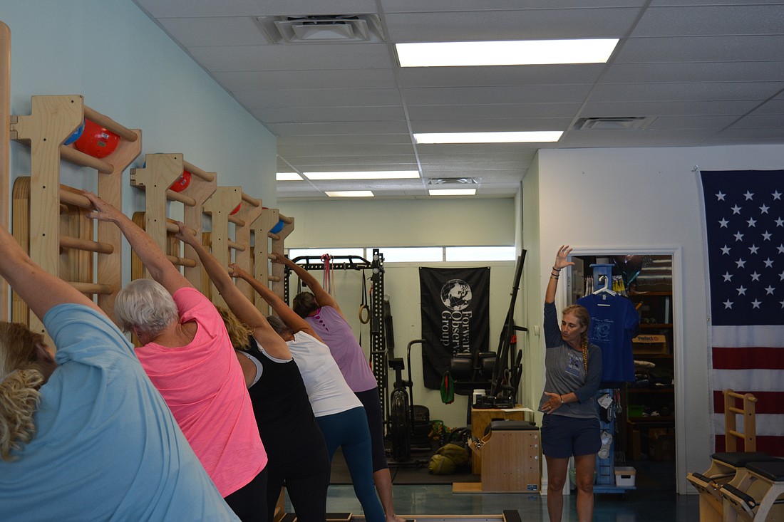 Emily Condensa instructs a Pilates Aligned session using the CoreAlign machine.