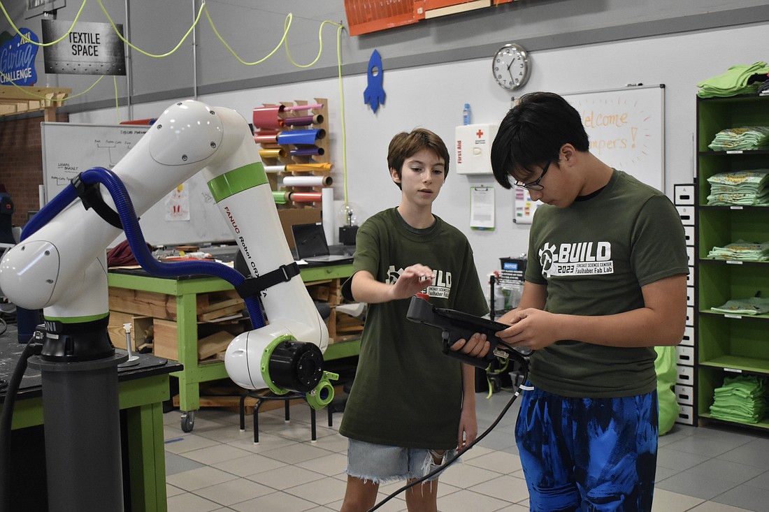 9th grade student Alex Lieberman and Evan Heck program the robot.