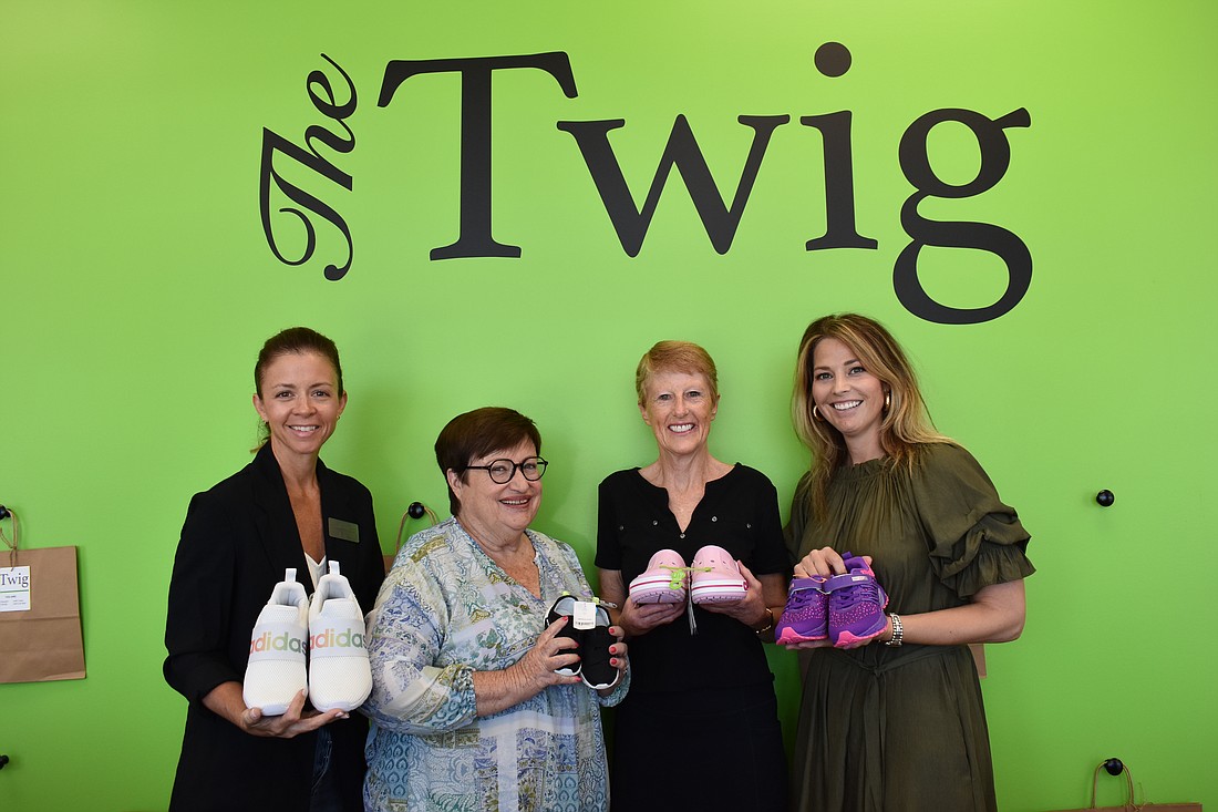 Lindsey May, Julie Swann, Kathy Hall and Jennifer Alokeh show off their favorite donated shoes to The Twig.