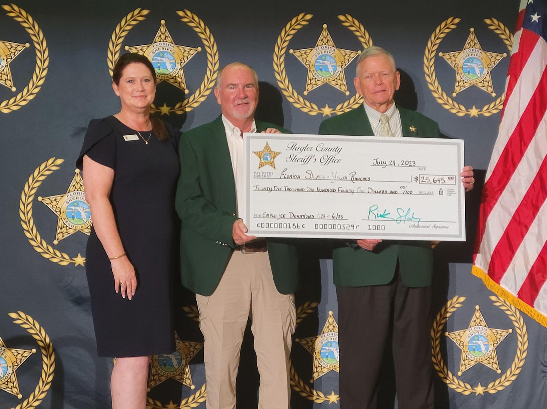 Sheriff Rick Staly presents a check of almost $26,000 from FCSO employees to the Florida Sheriffs Youth Ranches' Executive Vice President Maria Knapp and Levy County Sheriff and FSYR Board Chair Bobby McCallom. Photo courtesy of the FCSO