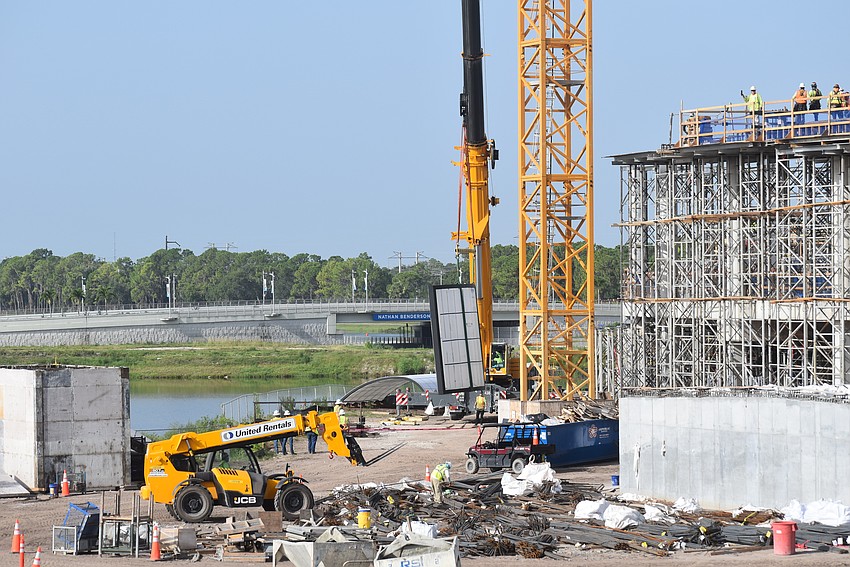 A special crane lifts the approximately 15-ton piece of acrylic that will become a main window in the Mote Science Education Aquarium's Gulf of Mexico Gallery tank that is two stories high.