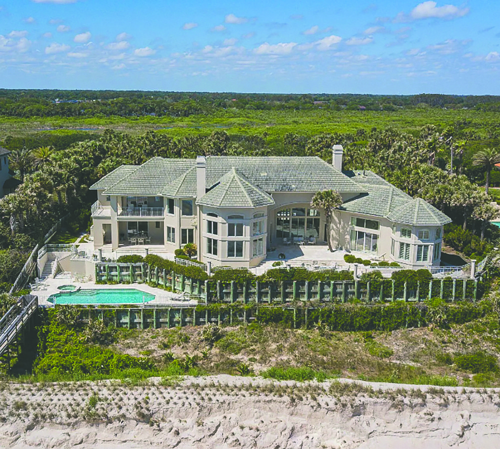 Oceanfront two-story home features five bedrooms, five full and two half-bathrooms, office, wine room, outdoor living space, pool, porches and dune walkover.