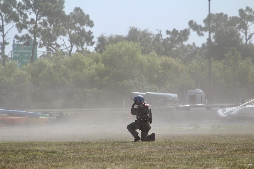 The area is cleared for landing, and dust flies like a sand storm as the helicopter gets closer to the ground.