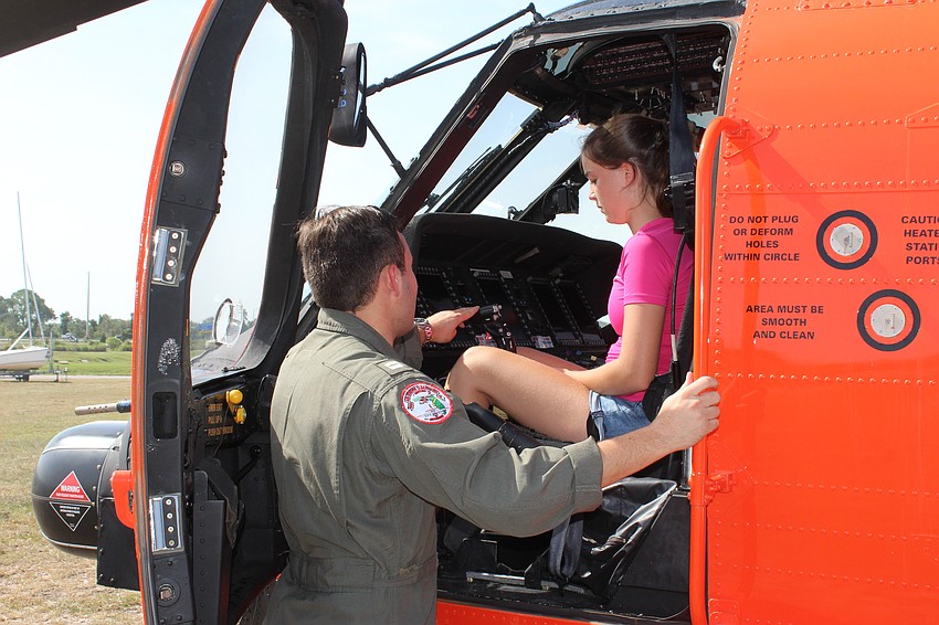 Lakewood Ranch resident Cate Kitcher had to be given instructions on how to get into the tight space of the cockpit before getting a tour of the instruments.
