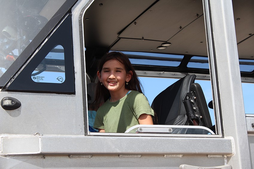 Country Club resident Harper Profito checks out the driver's seat in the response boat.