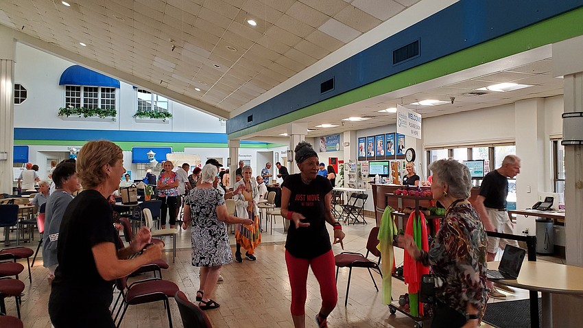 Daisy Saunders gets the whole room moving at the Senior Friendship Centers Wellness in Motion fair.