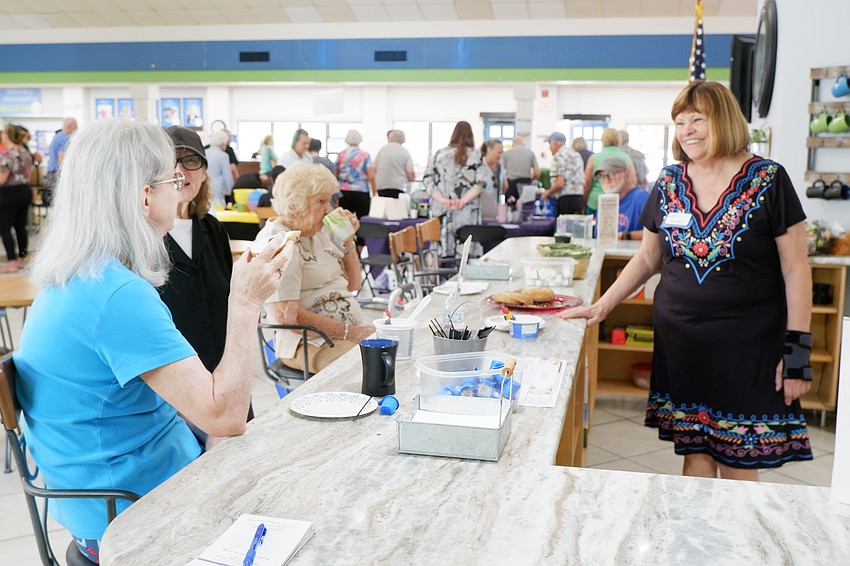 Volunteer Mary Lou Bryson (right) shares a laugh with Phyllis Miller, Sherry Waters and Dorothy Patrizi at the cafe at the Senior Friendship Centers Sarasota Activity Center during the Wellness in Motion Health & Services Fair.