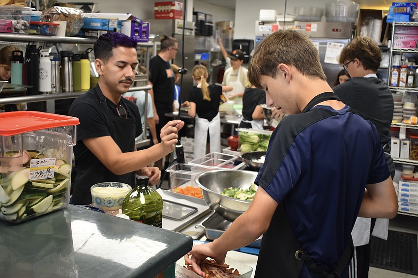 Nestor Escamilla offers instruction to 14-year-old Jack Greenwell.