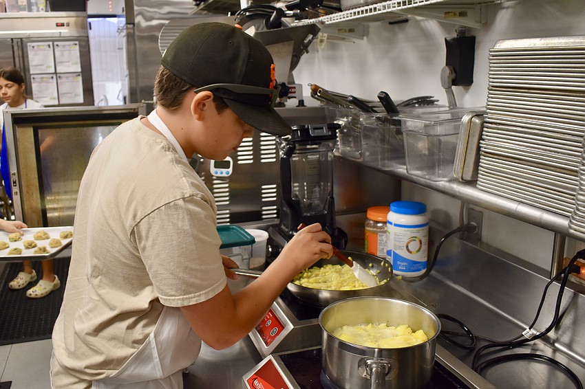 Alexander Edwards, 13, cooks different fruits.