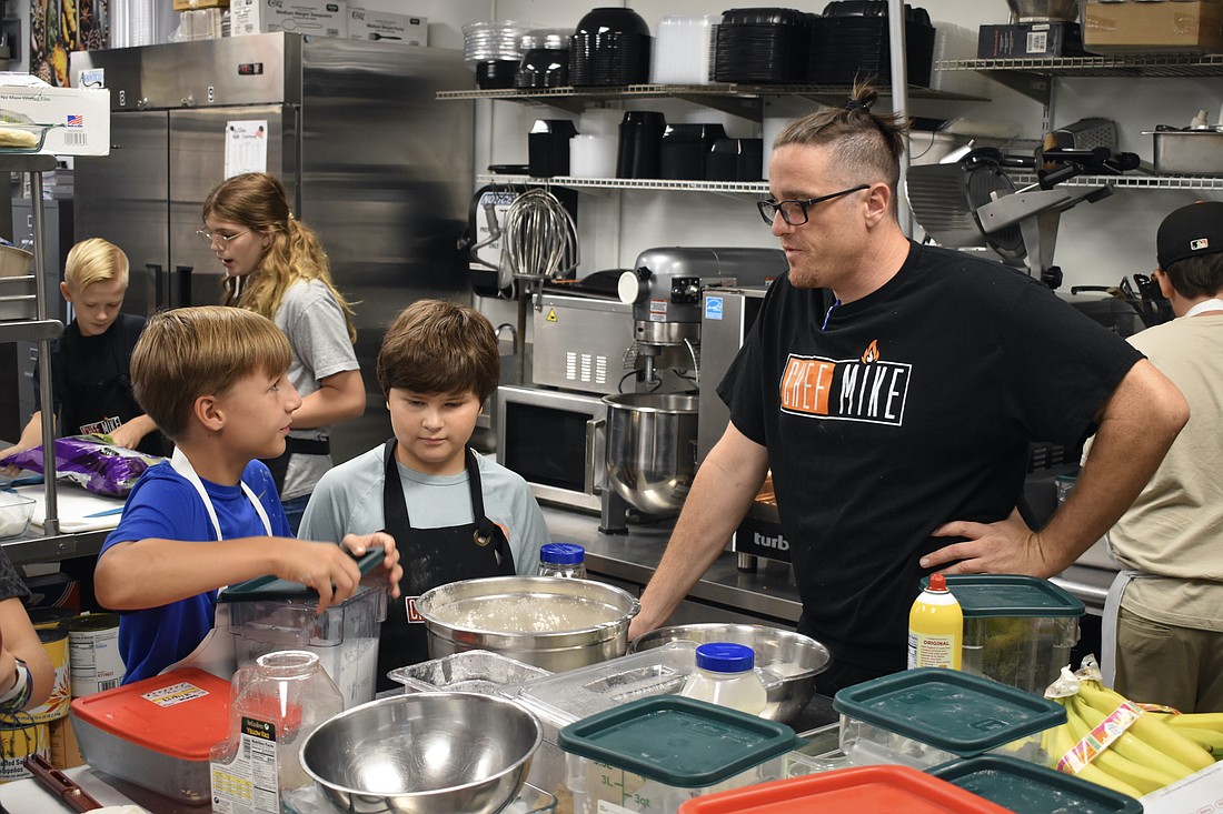 Eleven-year-old Henry Greenwell, 12-year-old Max Dinetz and Mike Donnerstag make banana bread together.