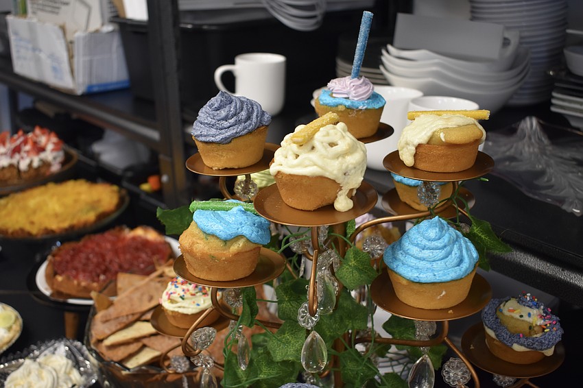 Cupcakes made by the kids are set out for parents to enjoy.