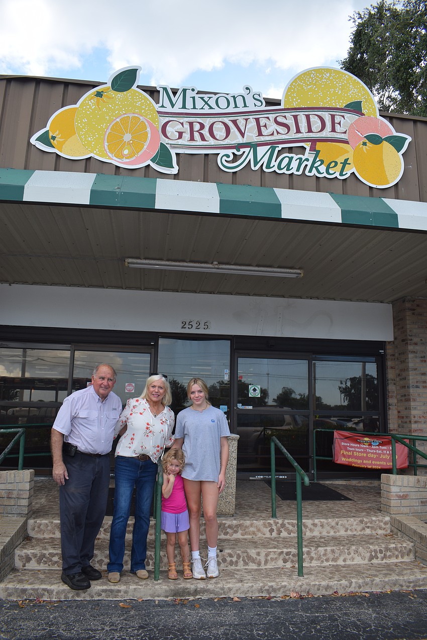 Dean and Janet Mixon say goodbye to Mixon Fruit Farms with their grandchildren Waverly Busa and Sully Hubert.