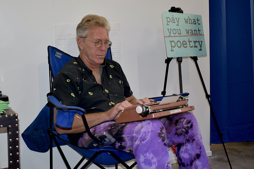 Steve McAllister types poems for visitors.