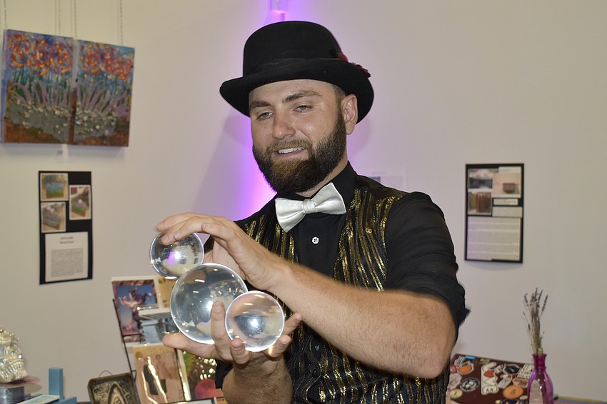 Illusionist Marshall Chandler levitates three globes.