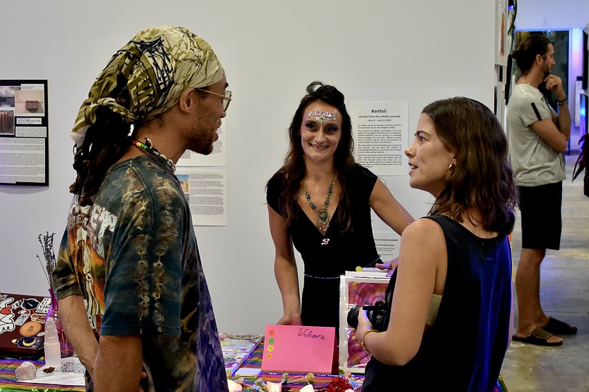 Mike Rivera, artist Drita Dawn Hajroja, and Jessica Rivera talk with one another.