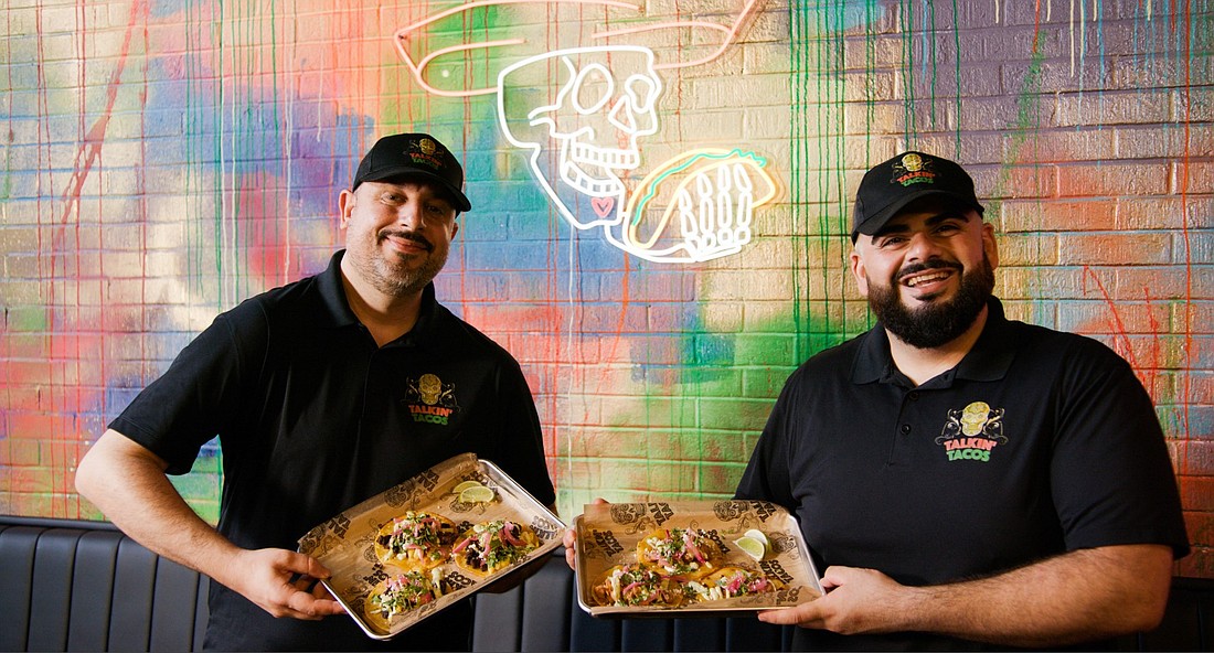 Franchisees Elias Ishak and Jason Malih show off some of the menu items they will be serving at Talkin’ Tacos in Jacksonville Beach.