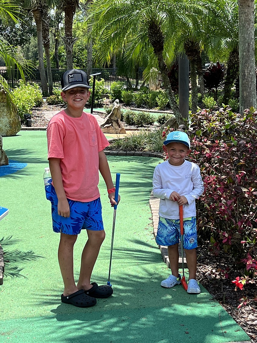 Bentley Thomas, a seventh grader at Lakewood Ranch Preparatory Academy, plays a round of mini golf with his brother Beau Thomas, who is a kindergartner, during their annual family vacation to Norris Lake, Tennessee.