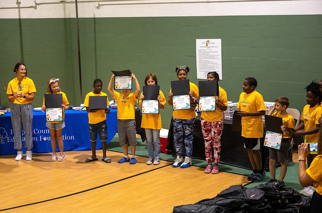 Students hold up their certificates at the completion of the Carver Center Summer Literacy Camp. Courtesy photo
