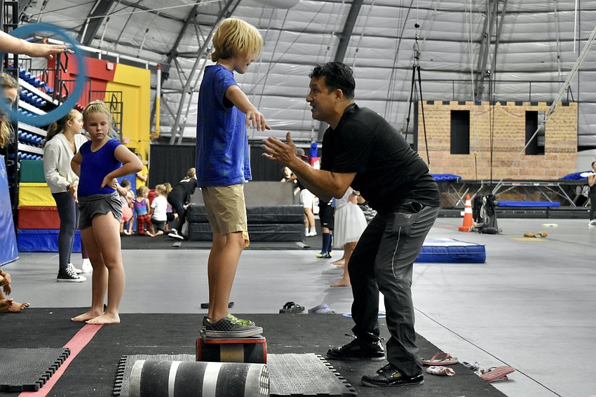 Gunnar DiFazio, 10, learns the rola bola from Benito Aguilar.