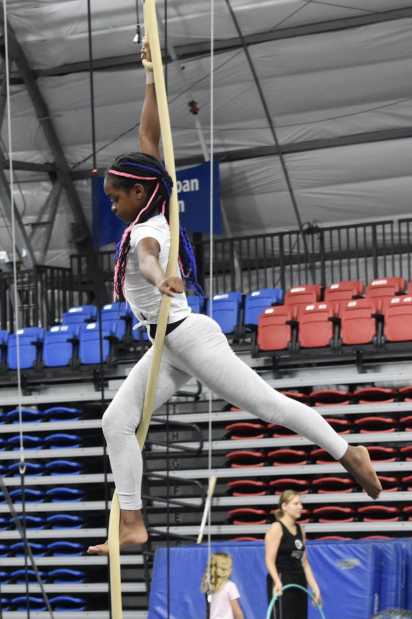 Isabella Francois, 10, swings through the air.