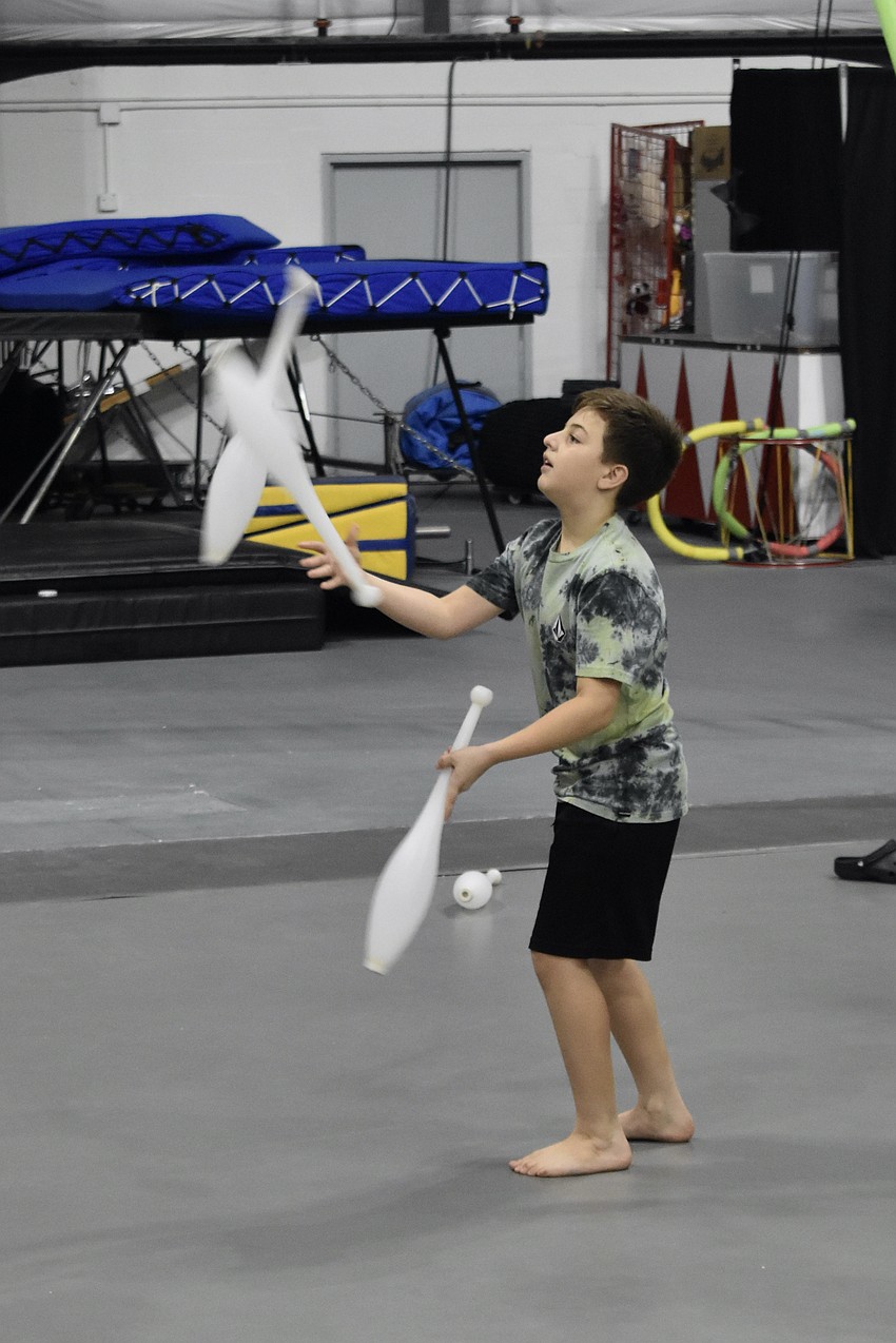 Jack Williams, 11, juggles three clubs.
