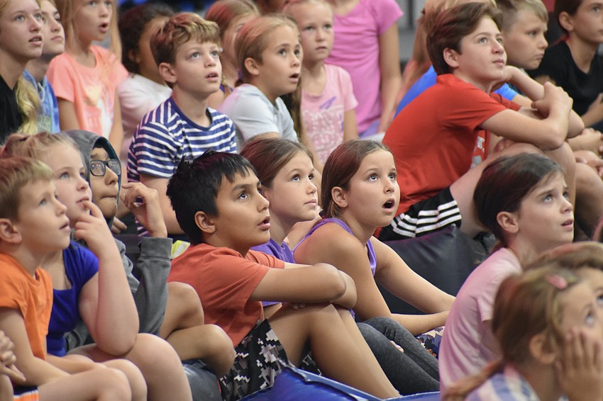 Emilio Guevara, Estella Stroth and Marney McClain, 9, marvel at a performance by camp staff.