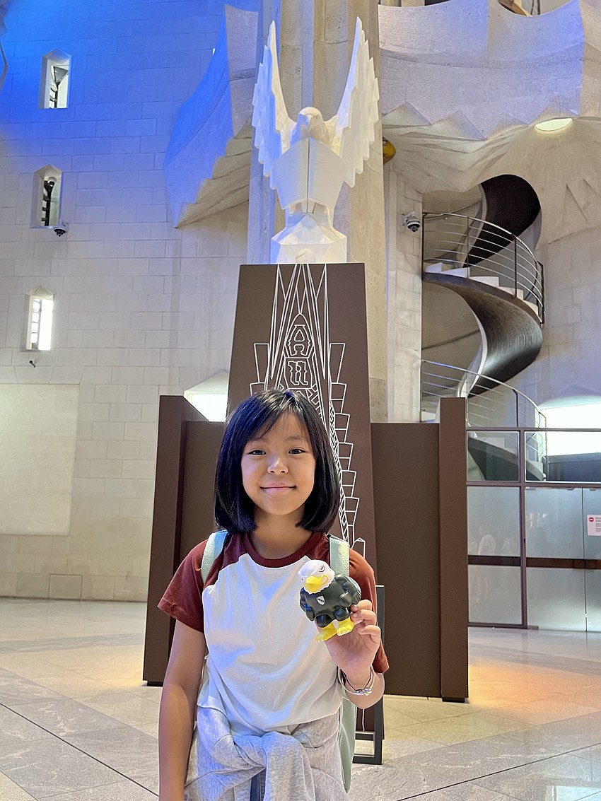 Linh Emma Nguyen, a fifth grader, shows off her Lakewood Ranch Preparatory Academy pride in front of the Statue of St. John as an eagle in Barcelona.