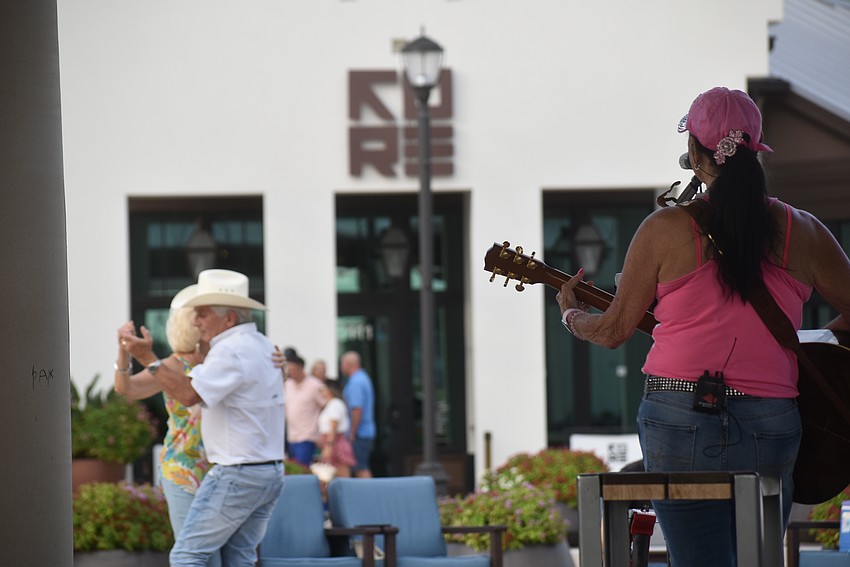 Some patrons watched Sheri Nadelman's entire show during Live Music at the Plaza and danced until darkness fell. Others enjoy a song or two and moved down the street to check out the restaurants.