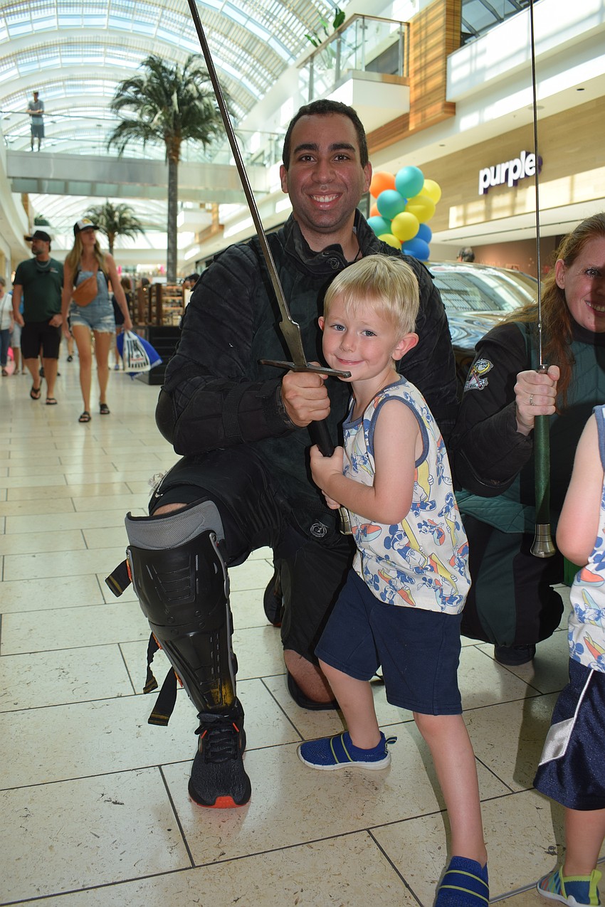 Chris Fontana with Steel Ring Academy shows his sword to East County's Matthew Servetz, who is 5.