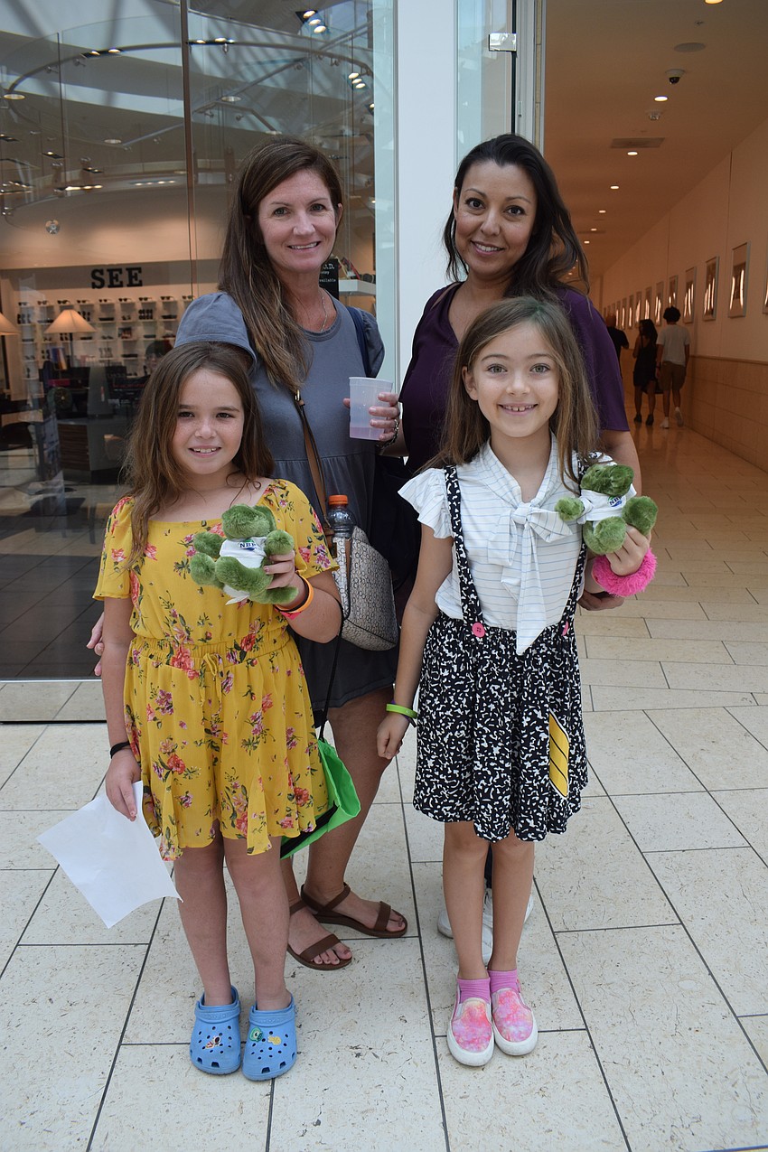 Lakewood Ranch's Abbey Granata, who is 9, and her mother, Denise Granata, and Sarasota's Melanie Petty and her 9-year-old daughter Colette Petty collect school supplies and goodies at the Back to School Bash.