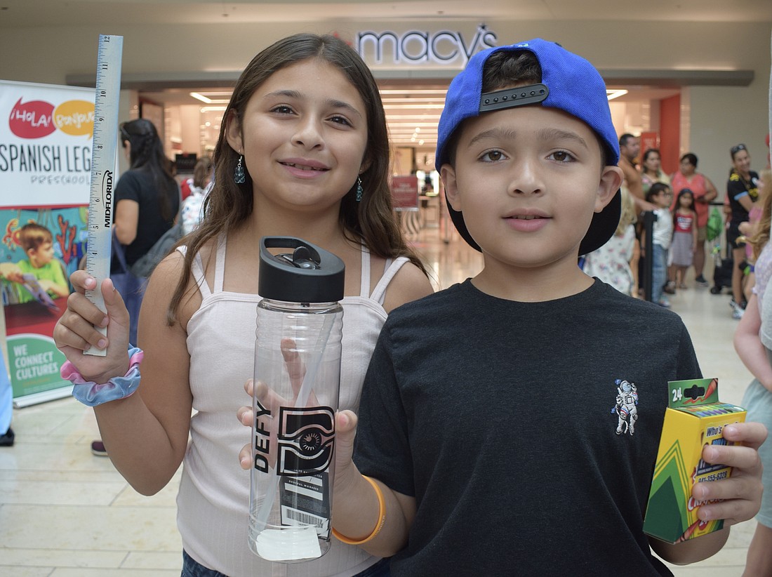 Bradenton's Nicole Figueroa, who is 11, and Abdiel Figueroa, who is 8, show off the school supplies they received during the Back to School Bash.