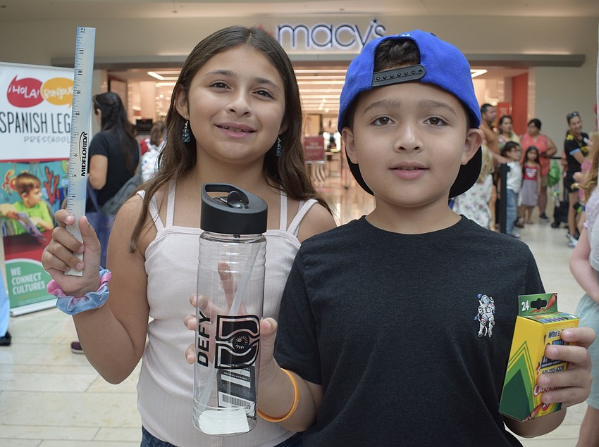 Bradenton's Nicole Figueroa, who is 11, and Abdiel Figueroa, who is 8, show off the school supplies they received during the Back to School Bash.