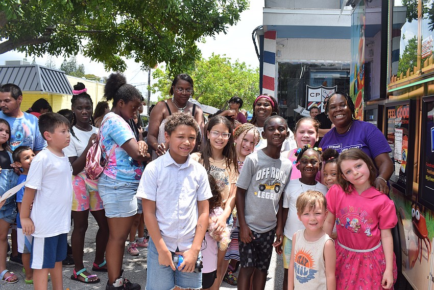 April Glasco lines up children to get a free Kona Ice.