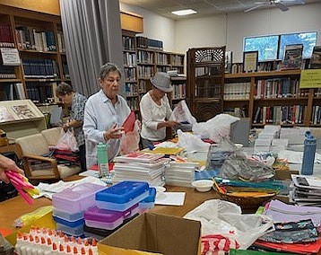 The Social Action Committee at Temple Beth Israel packs school supplies for the SCLO back-to-school drive.