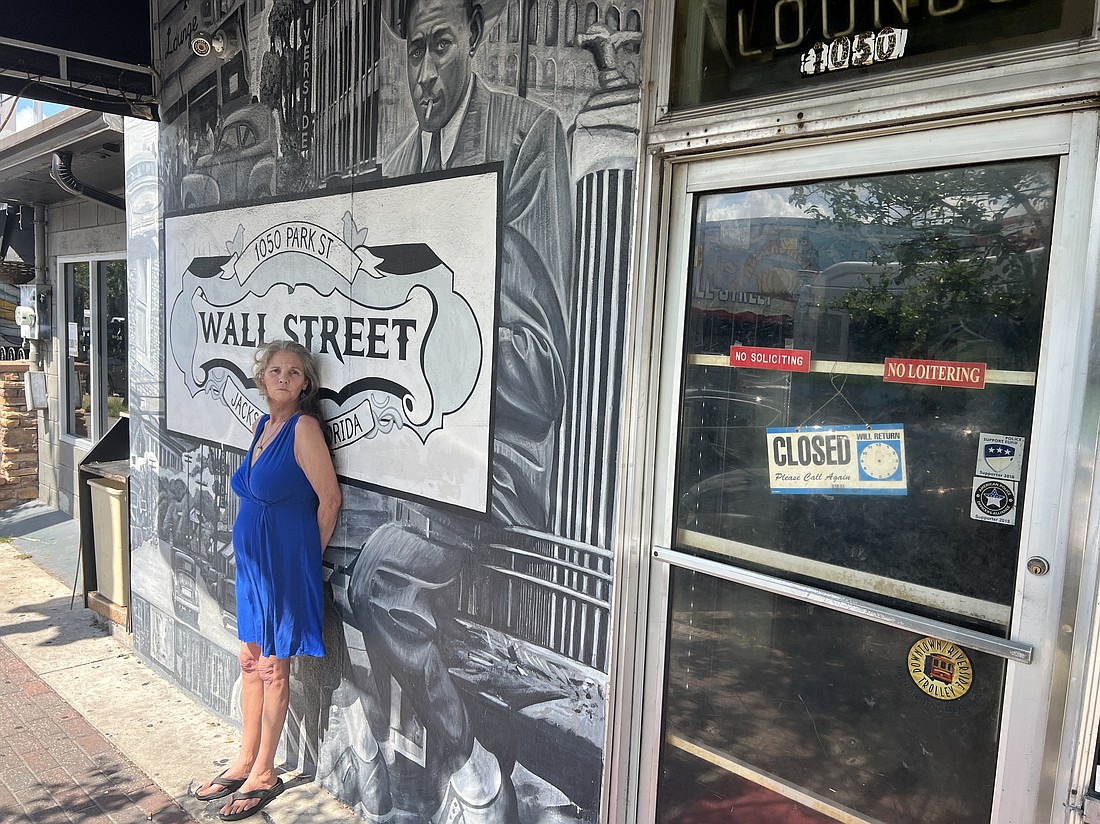 Janie Pearl “JP” Canova stands outside the Wall Street Deli & Lounge, where she has worked since 1995.
