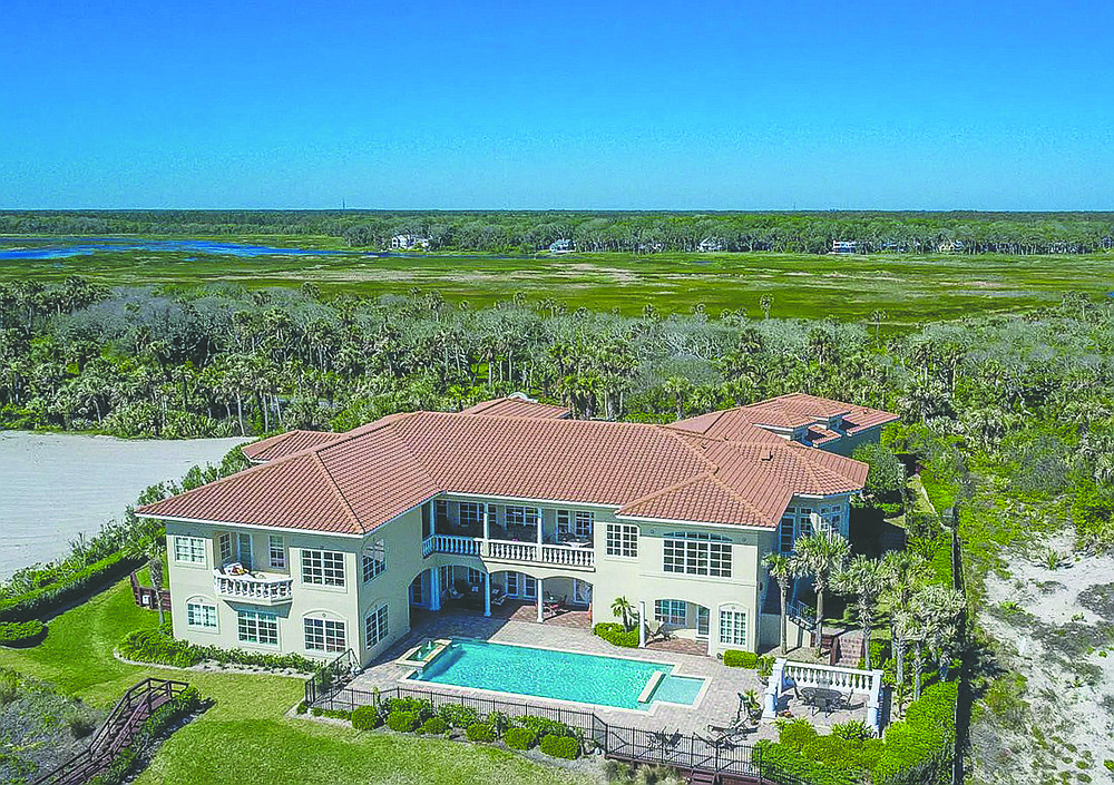 This oceanfront two-story home features five bedrooms, six full and two half-bathrooms, office, bonus room, sauna, wine cellar, theater, porches, patio, elevator, four garage spaces, pool and dune walkover.