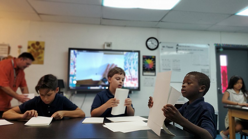 Leandro Rodriguez, Lucian Frazee and Trabeus Lemon work on their sketchbook projects in the fifth-grade art class at the Suncoast School for Innovative Studies.