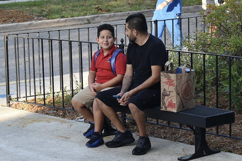 Dominic Guisado, 8, and Julio Guisado talk before school begins.