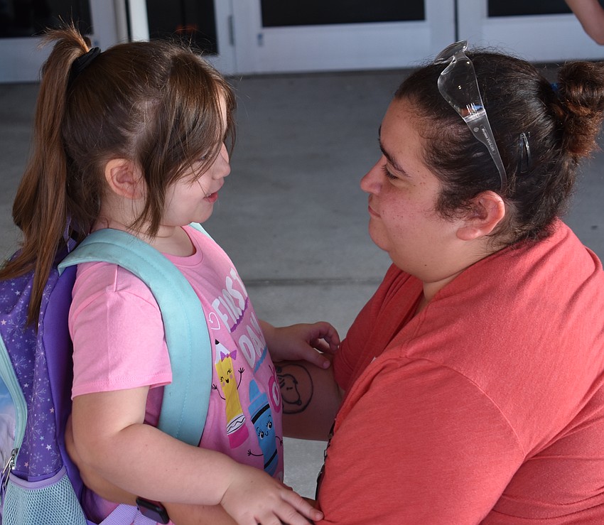 Brianna Cross says goodbye to her daughter Averleigh, who is starting her first day in kindergarten at Freedom Elementary. 