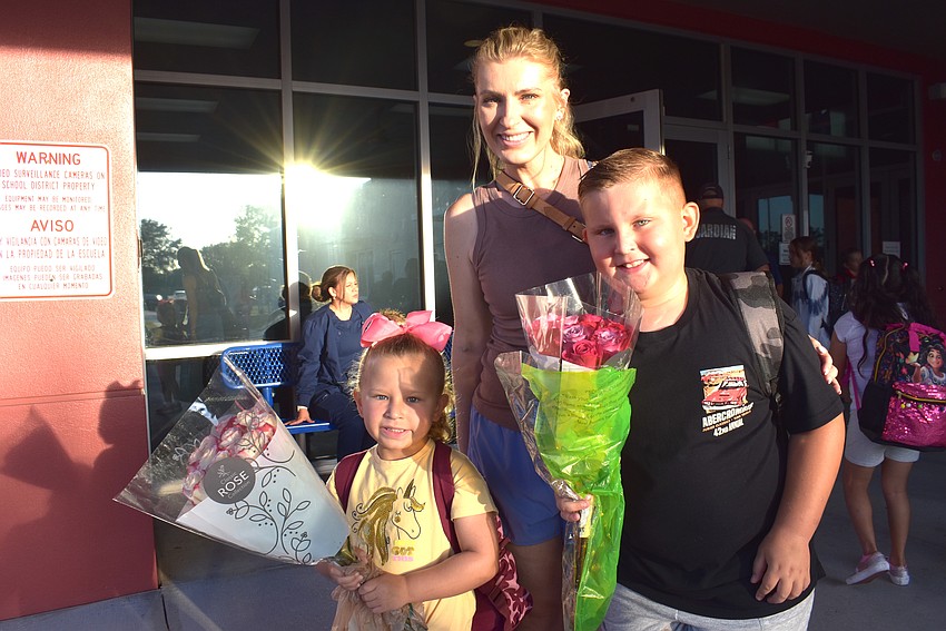 Pre-K student Olivia Turko and her brother, fourth grader Benjamin Turko bring flowers for their Freedom teachers. Their mom, Tatyana Turko says, 